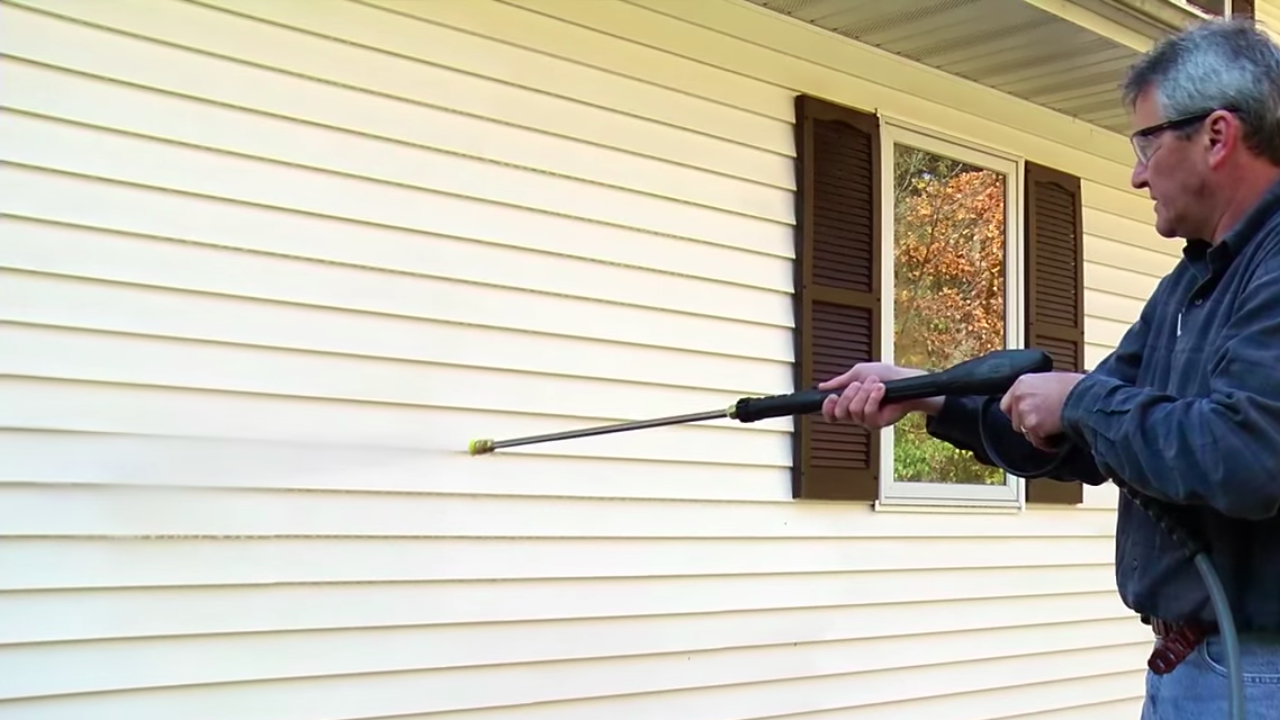 Professional house exterior siding power washing close-up